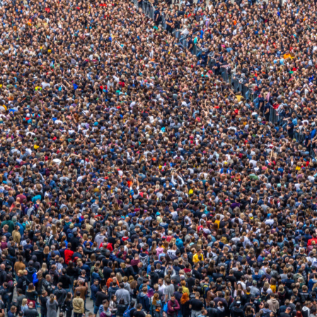 image of thousands of people standing closely together. mainly their heads and shoulders are only seen